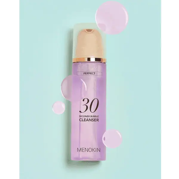Billedtekst, der viser en Menokin 30 Seconds Bubble Cleanser-flaske med plejende skum til rensning af huden, perfekt til en frisk hudplejerutine.
